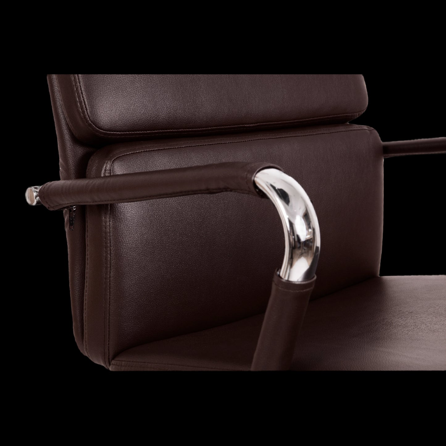 Brown leather chair with a metallic armrest on a black background