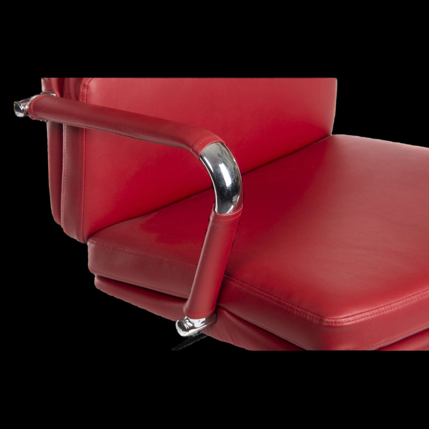 Red leather chair with chrome armrests on a black background