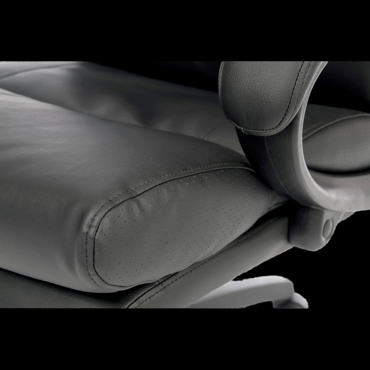 Close-up of a black office chair with visible stitching