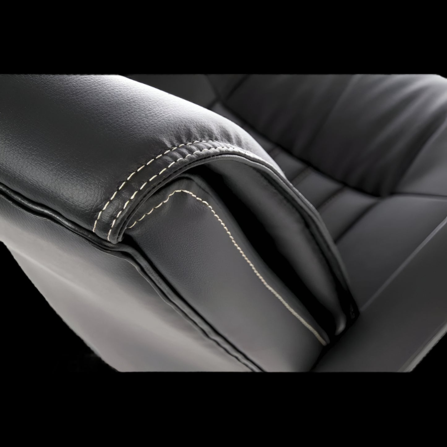 Close-up of black leather office chair seat with visible stitching detail.