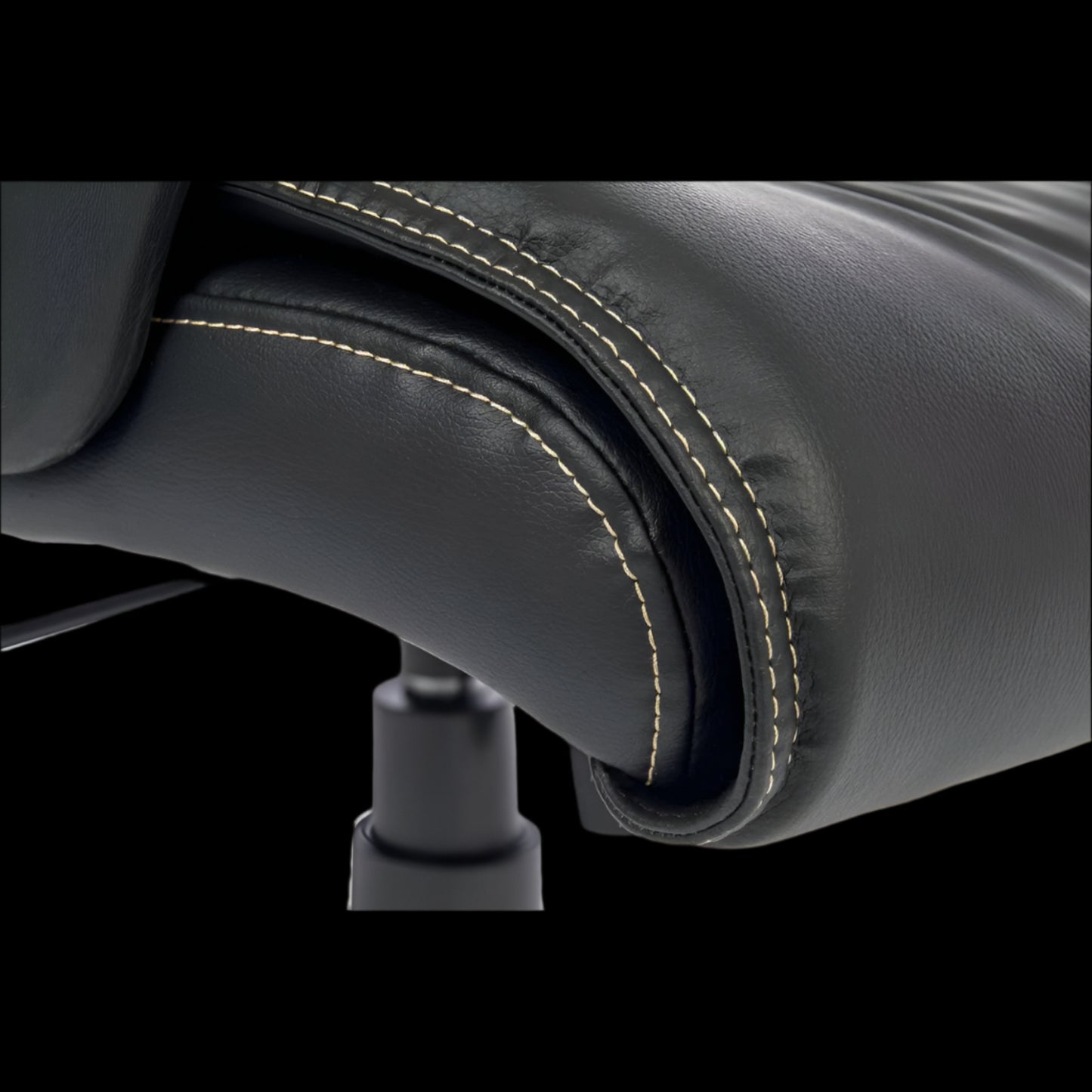 Close-up of a black leather chair with visible stitching detail.