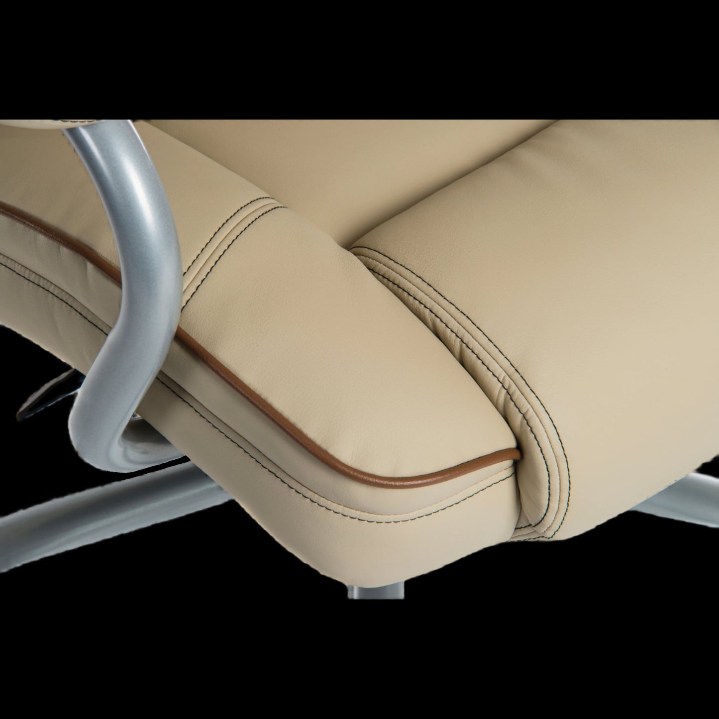Close-up of a beige office chair with armrests on a black background