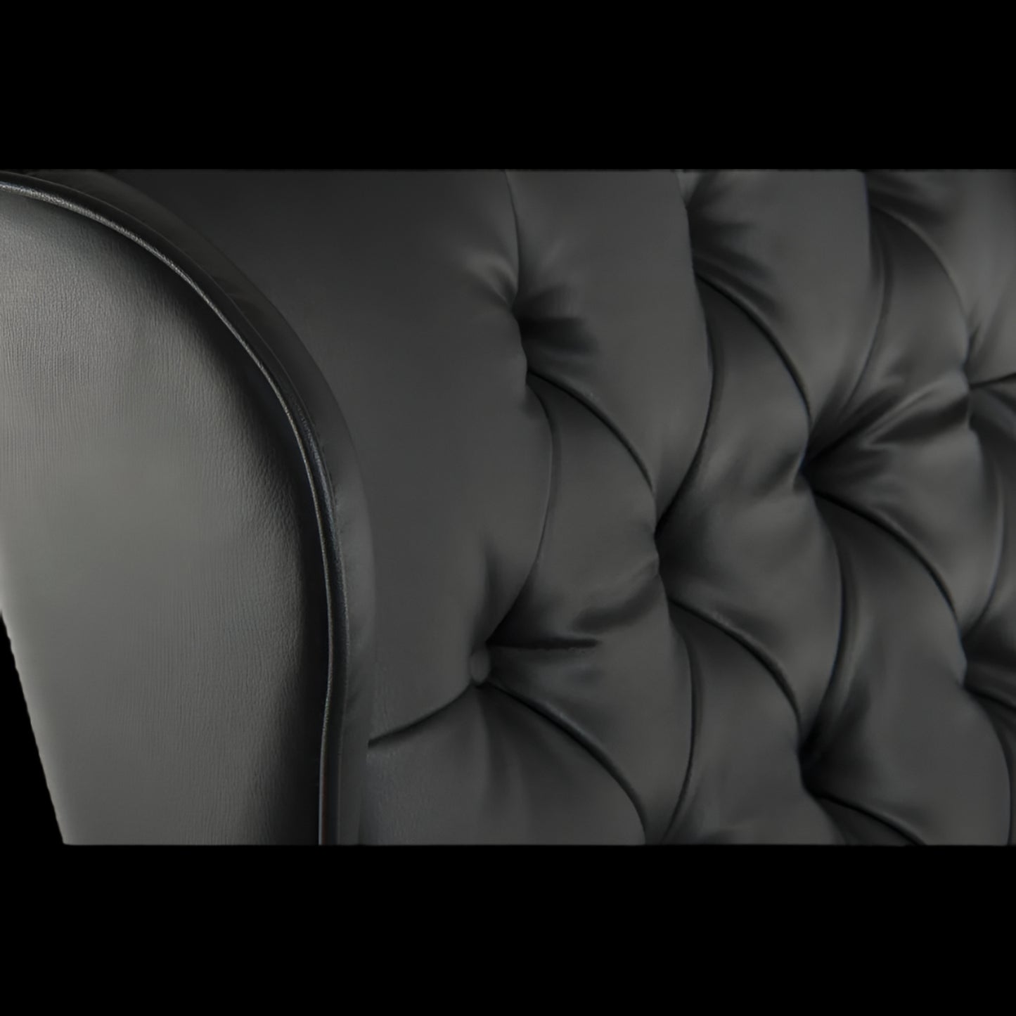 Close-up of a black tufted sofa cushion