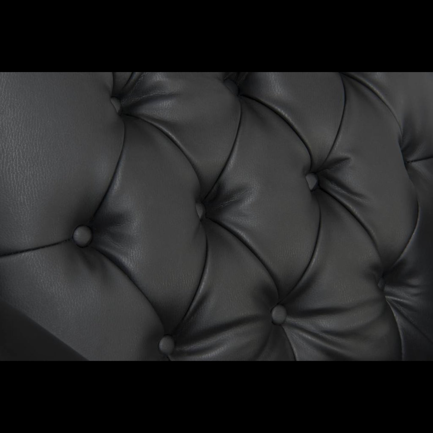 Close-up of a tufted black leather surface