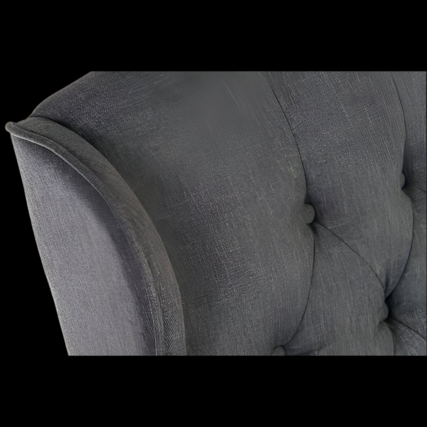 Gray upholstered chair with tufted backrest and armrests on a black background