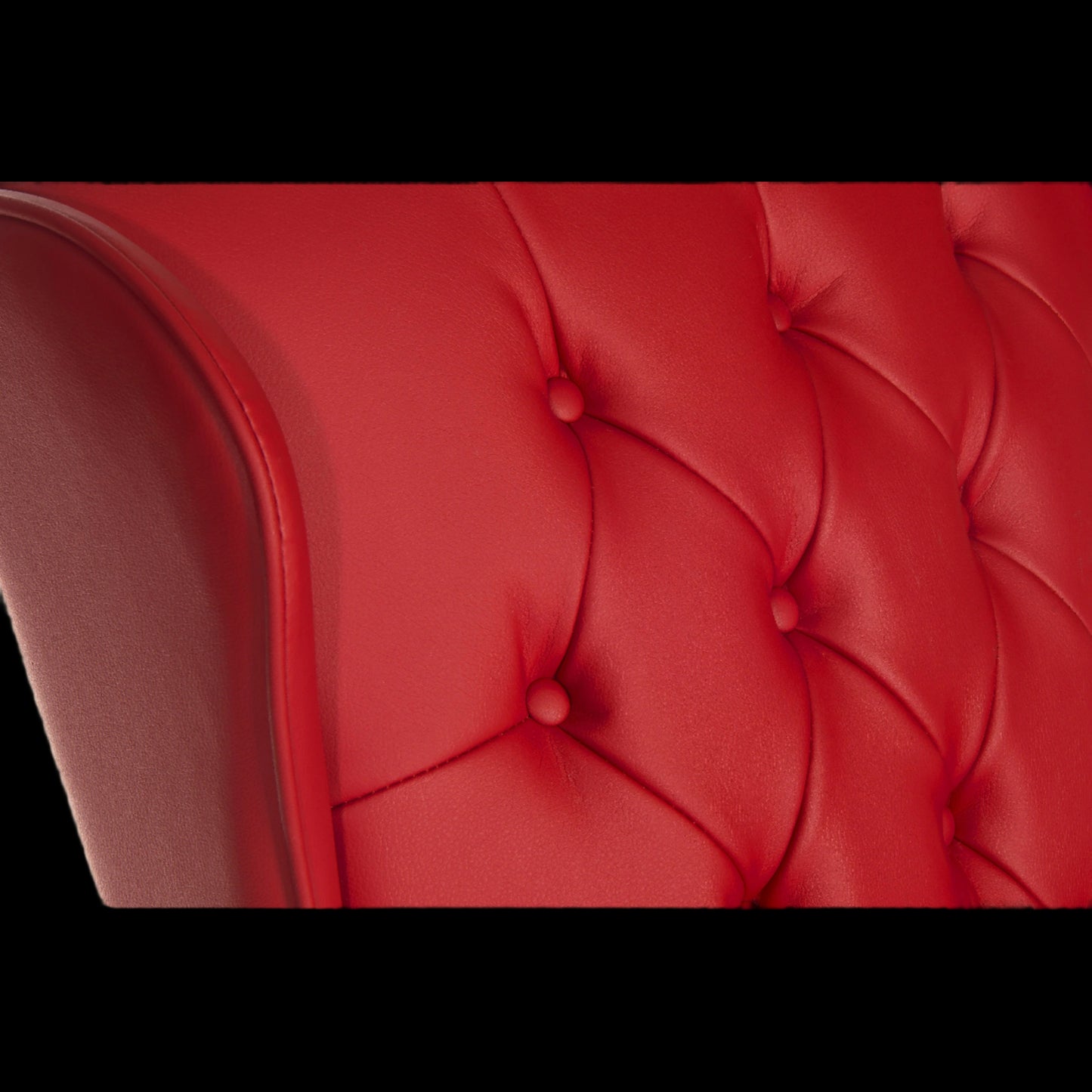 Close-up of a red tufted chair with a black border
