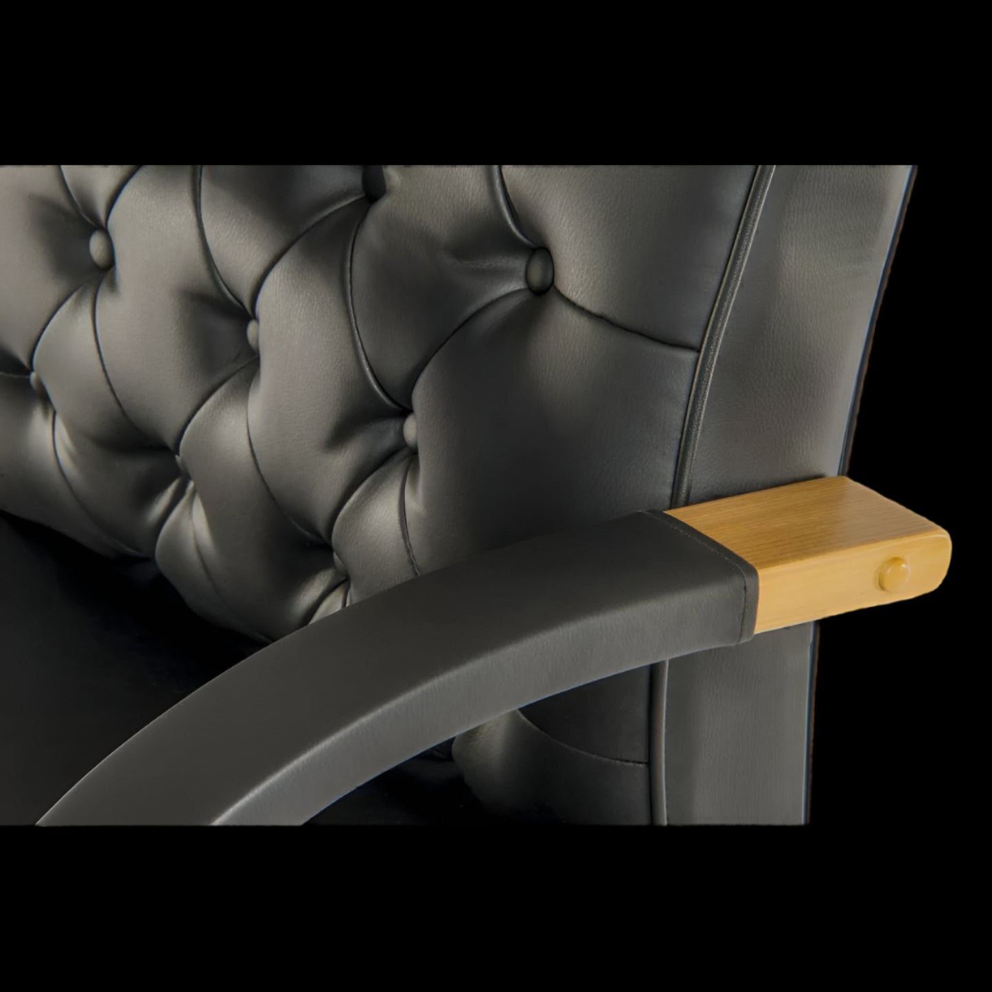 black upholstered chair with a wooden armrest on a black background