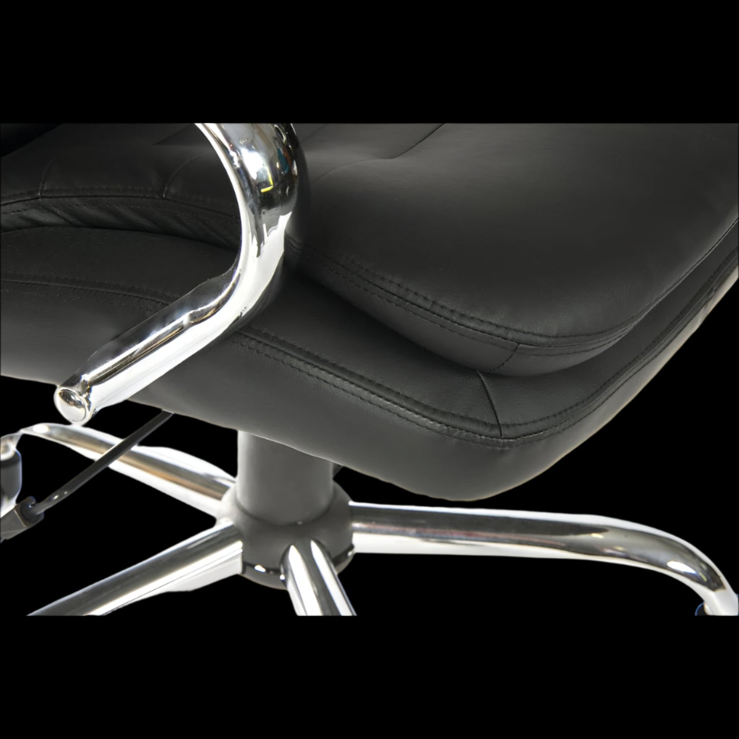Black office chair with chrome base on a black background