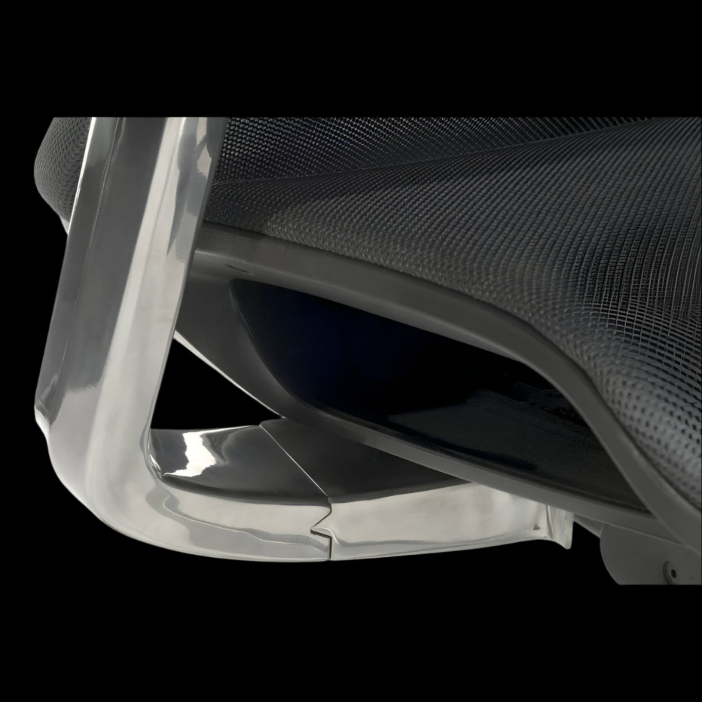 Close-up of a chair with a clear plastic cover on a black background