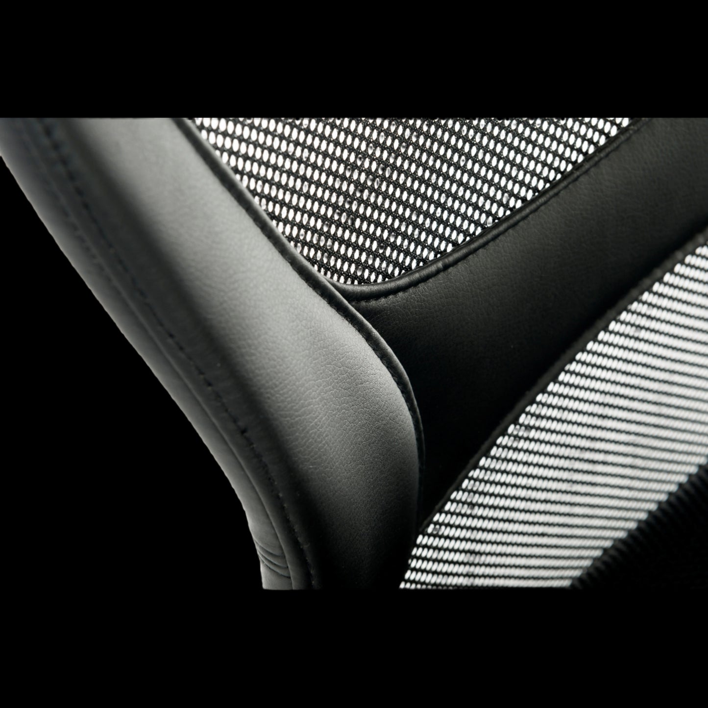 Close-up of a black office chair with mesh backrest