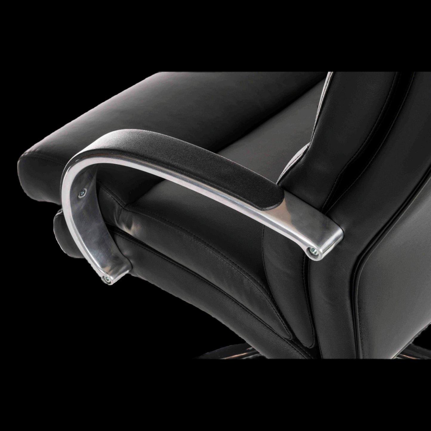 Close-up of a black office chair with armrests on a black background