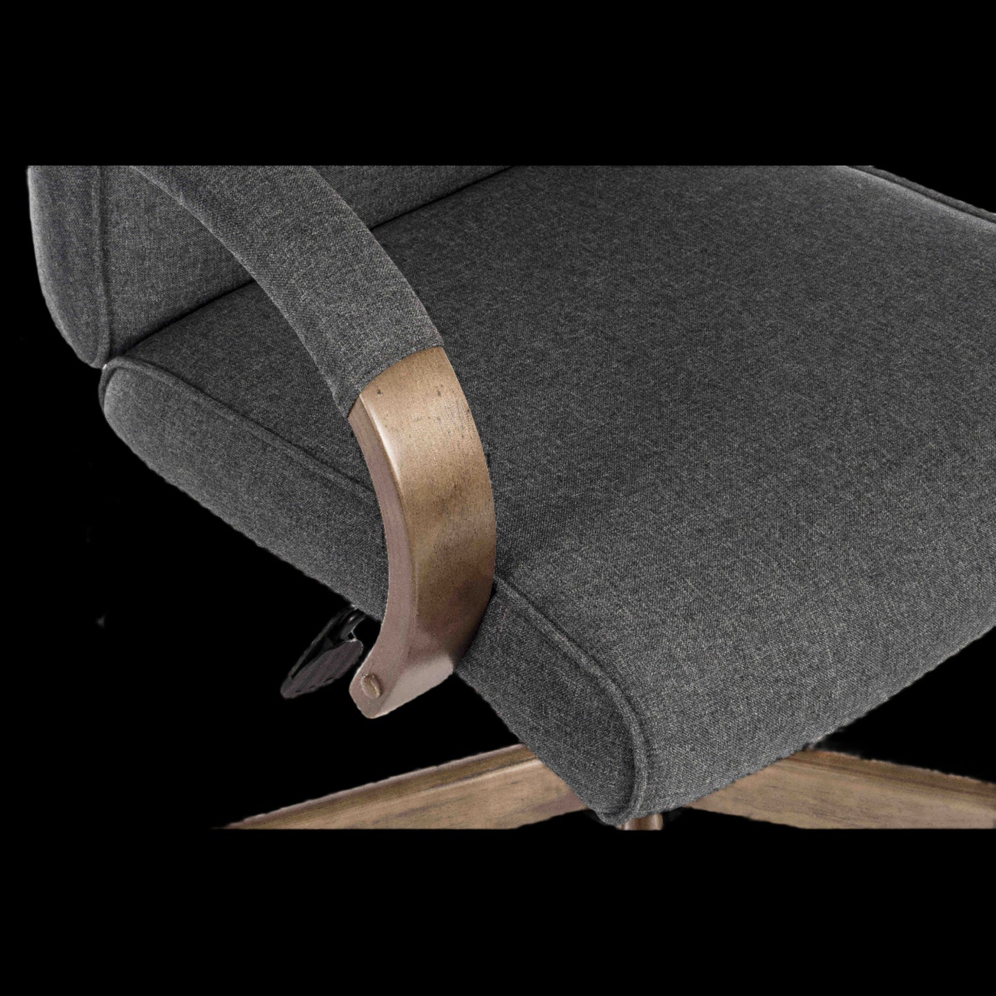 Gray upholstered chair with wooden armrest on a black background