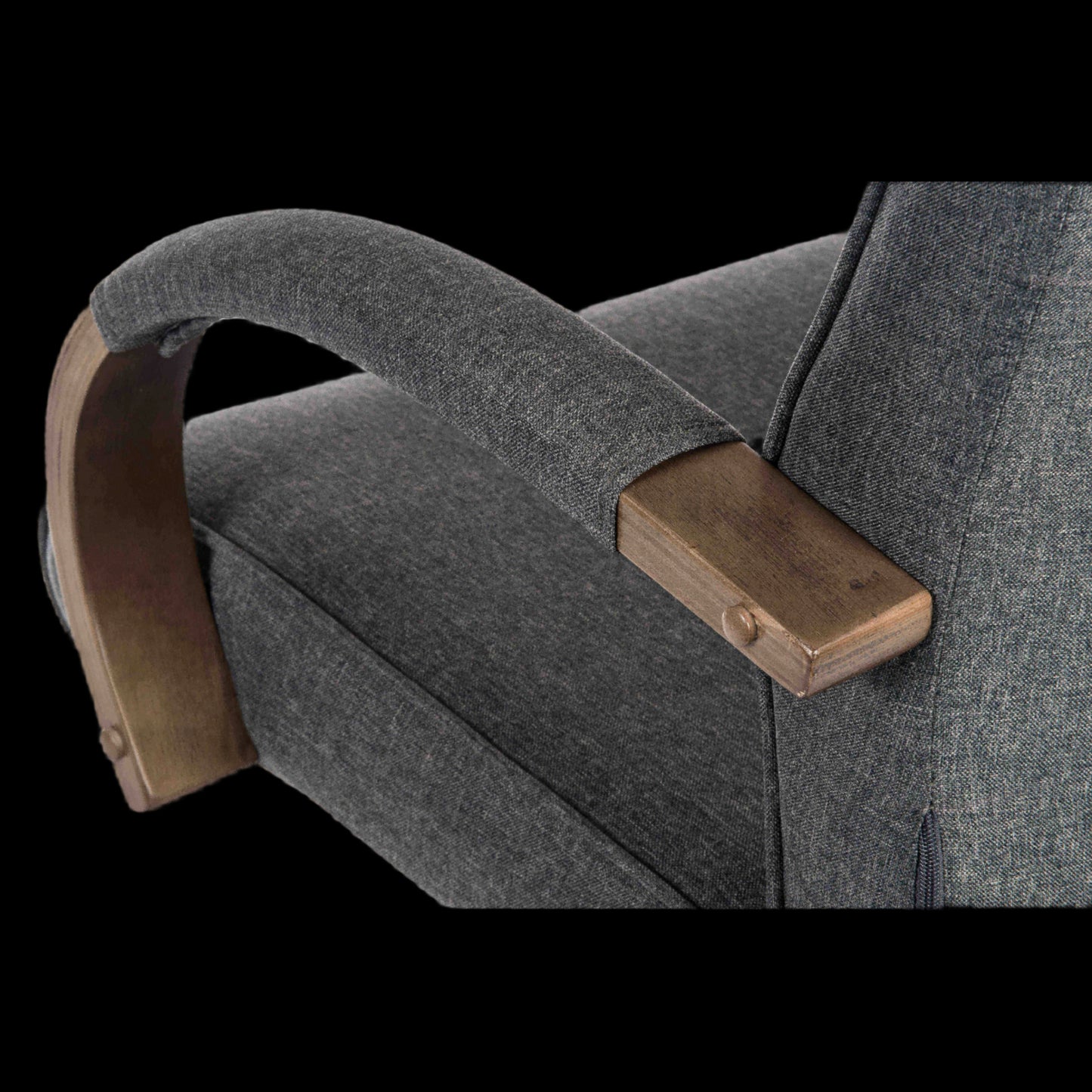 Gray upholstered chair with wooden armrests on a black background