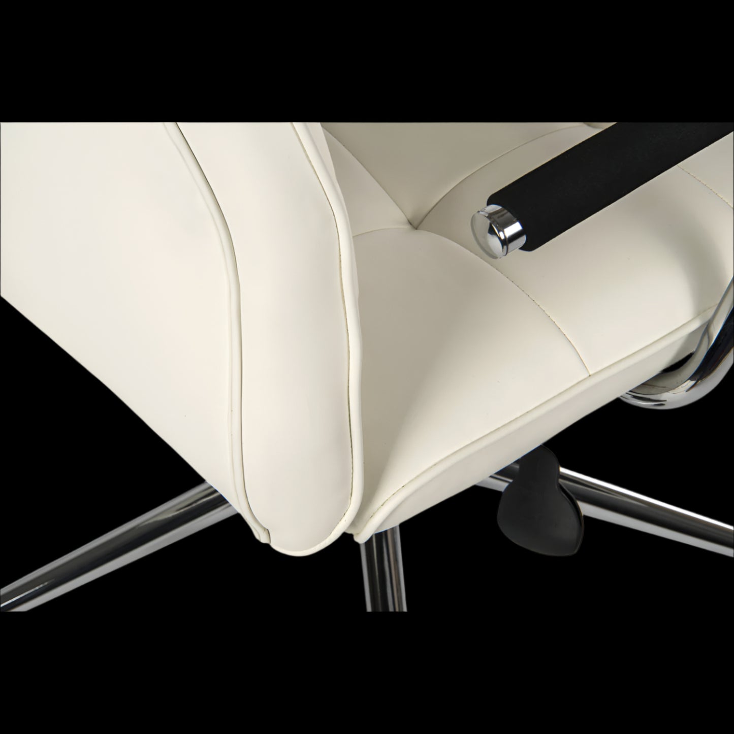 Close-up of a beige office chair with a black armrest on a black background