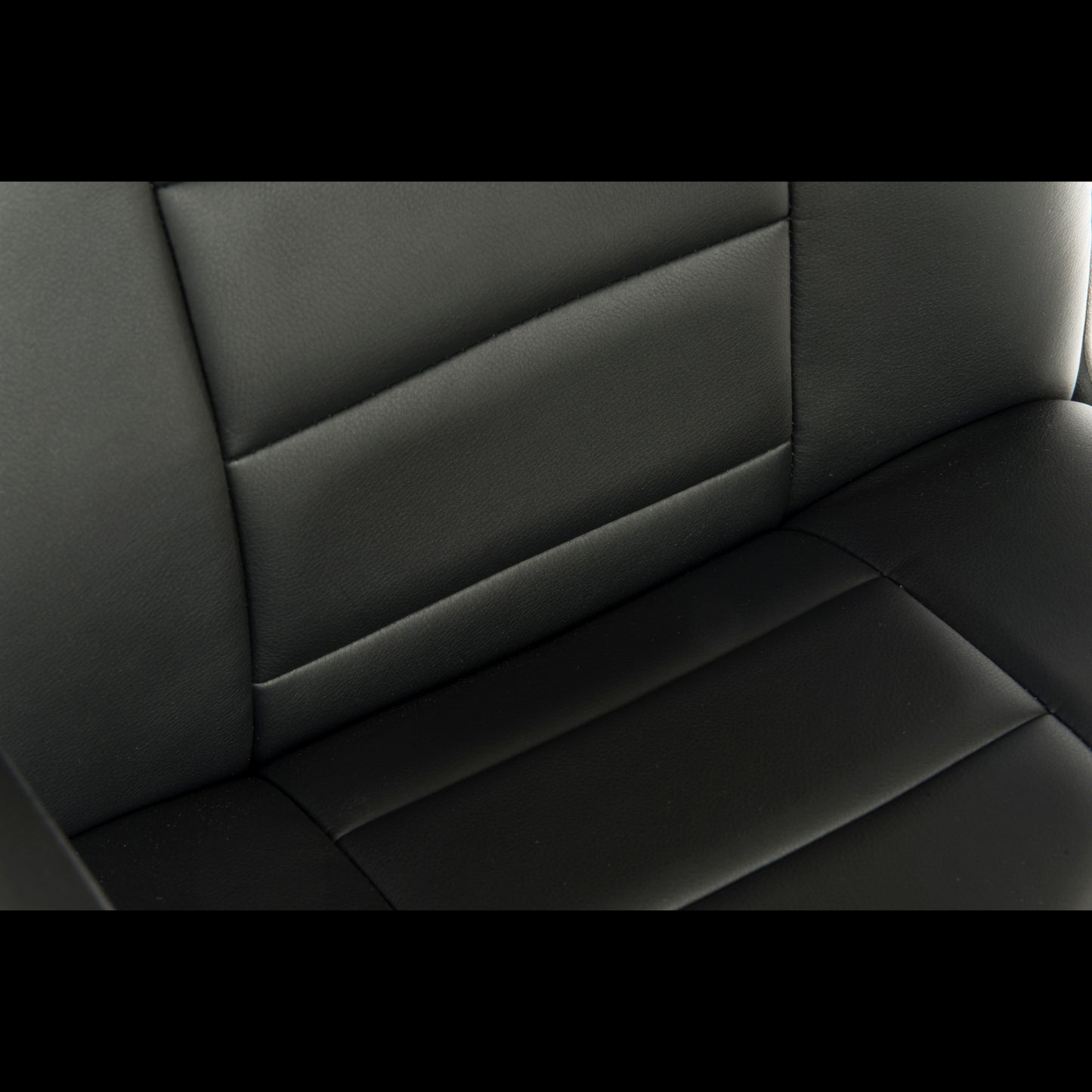 Close-up of a black leather office chair seat with stitching details