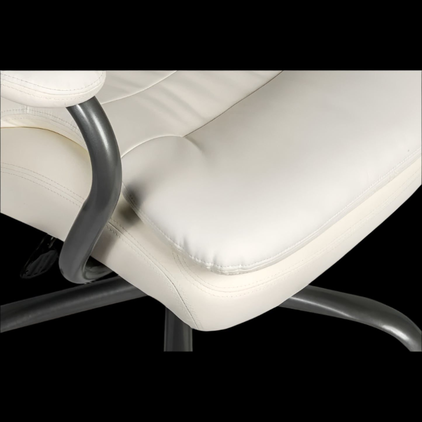 Close-up of a white office chair with a black base on a black background