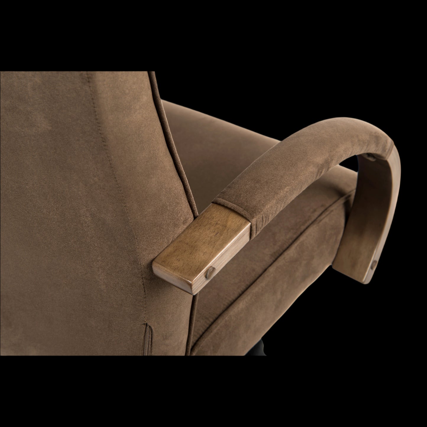 Brown armchair with wooden armrest on a black background