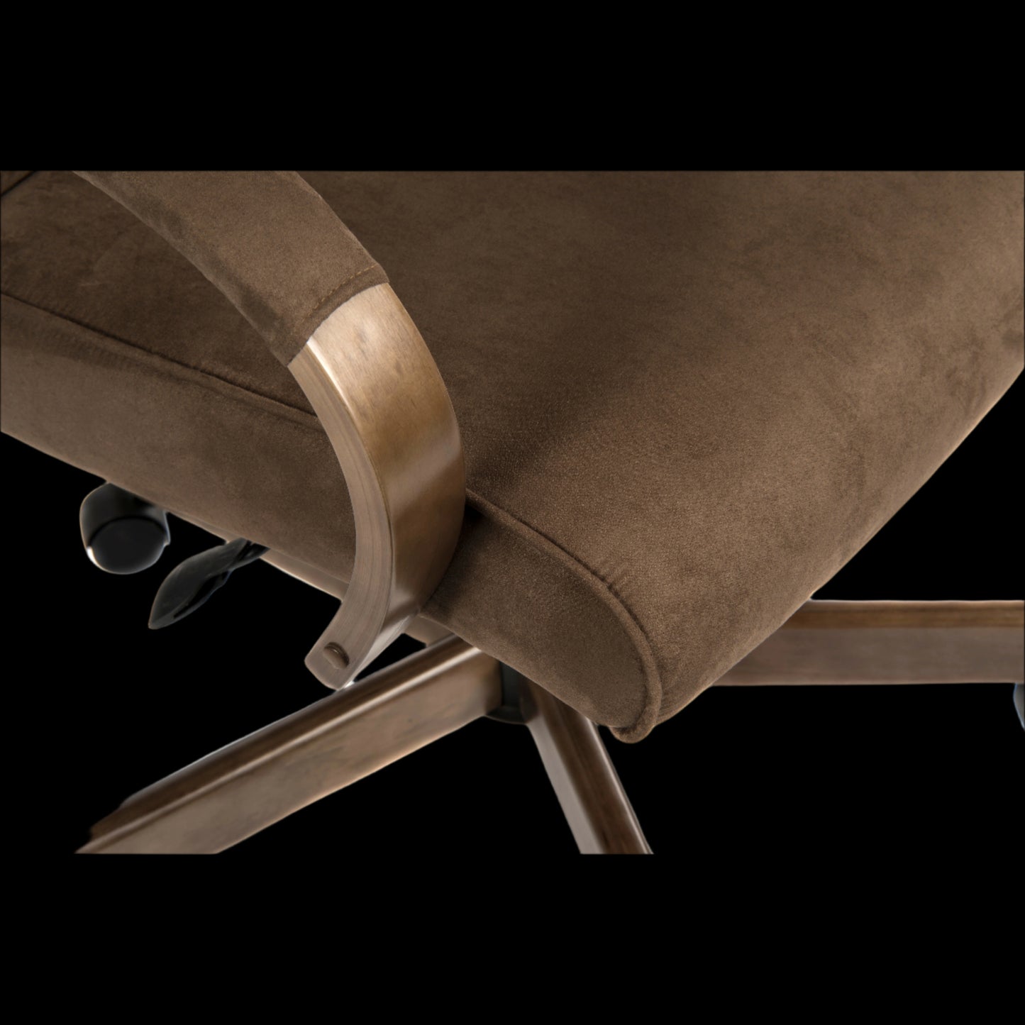Close-up of a brown chair with metallic armrests on a black background