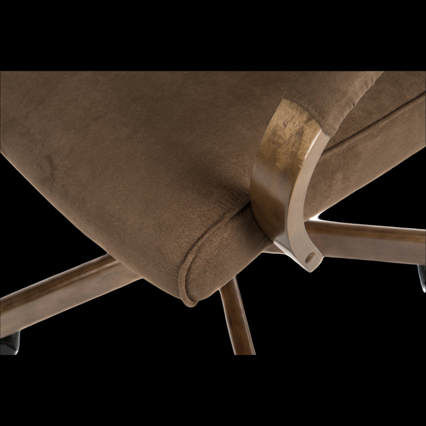 Close-up of a brown upholstered chair with gold metal armrests on a black background