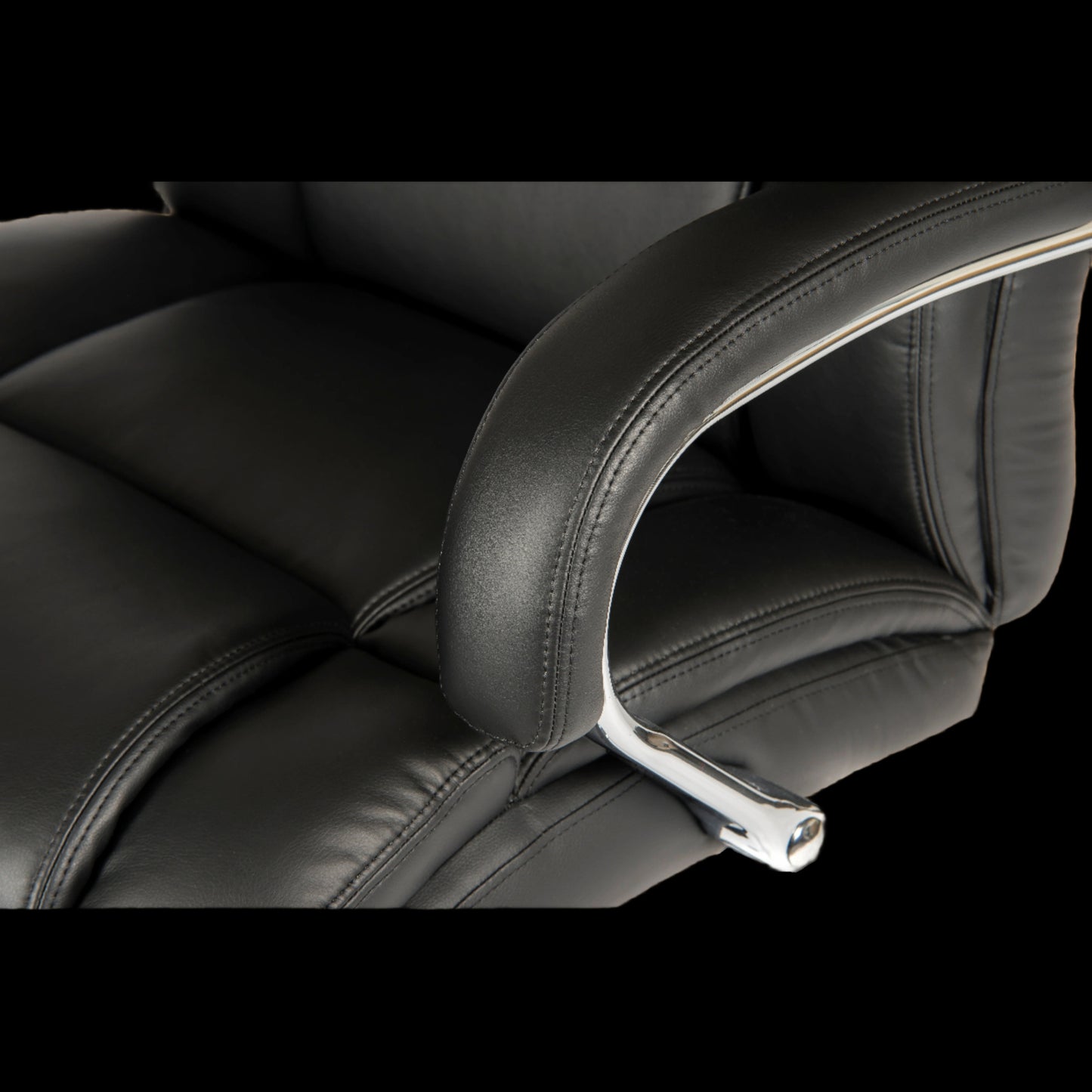 Close-up of a black office chair with headrest and armrests.