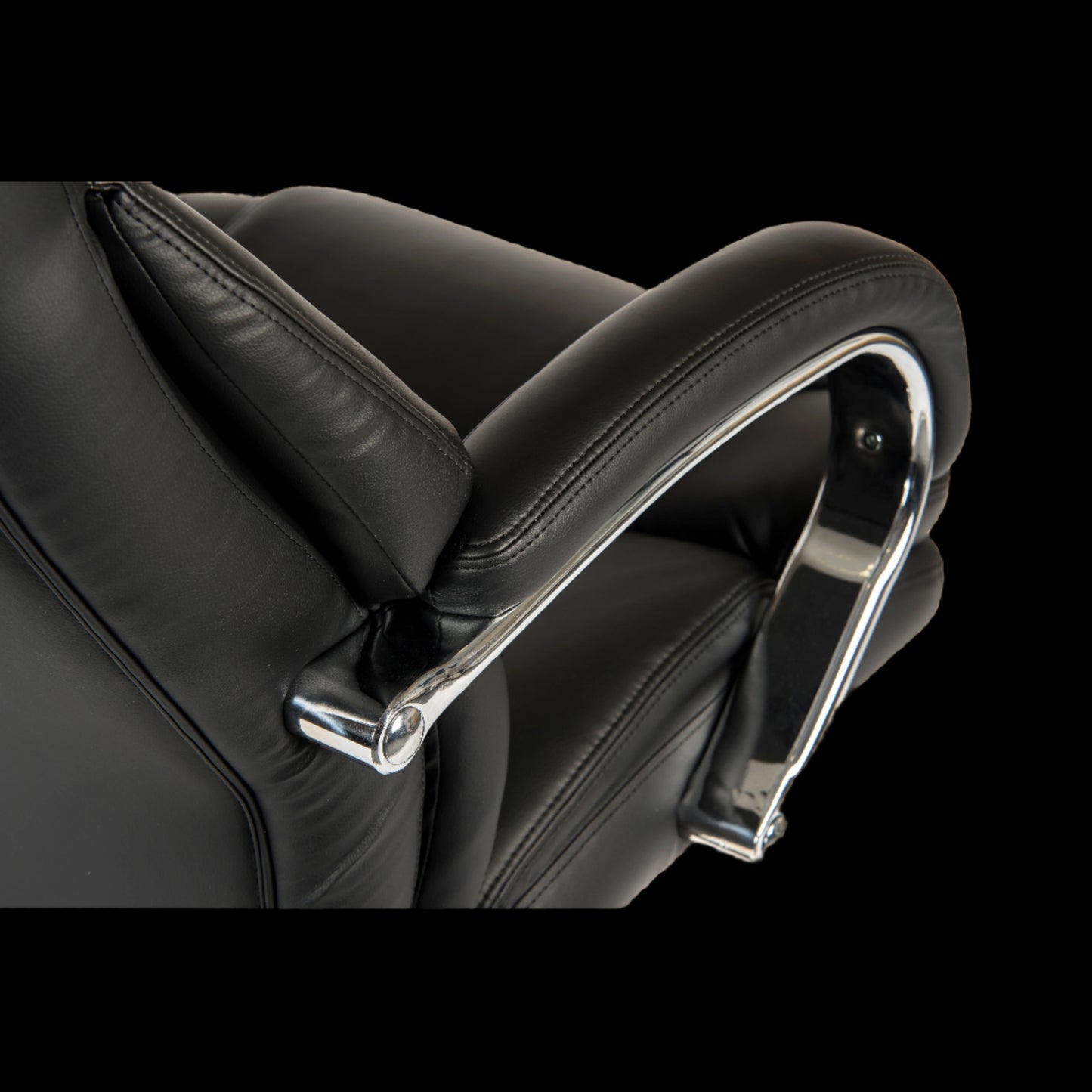 Close-up of a black leather office chair with chrome armrests on a black background