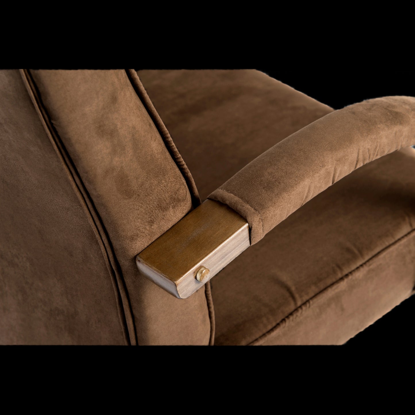 Brown upholstered chair with wooden armrest and metal bracket on a black background