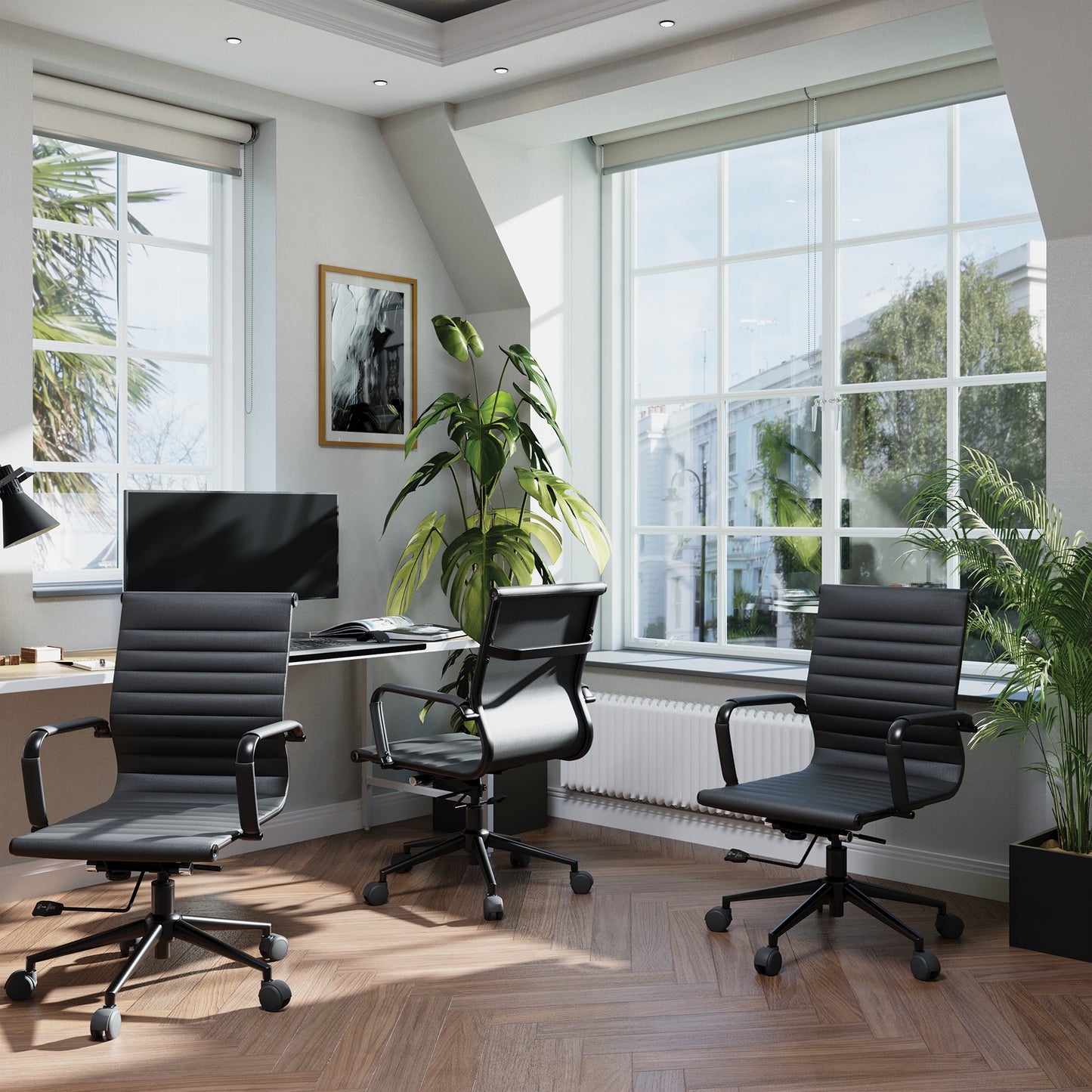 Modern office with black chairs, a desk, and large windows.