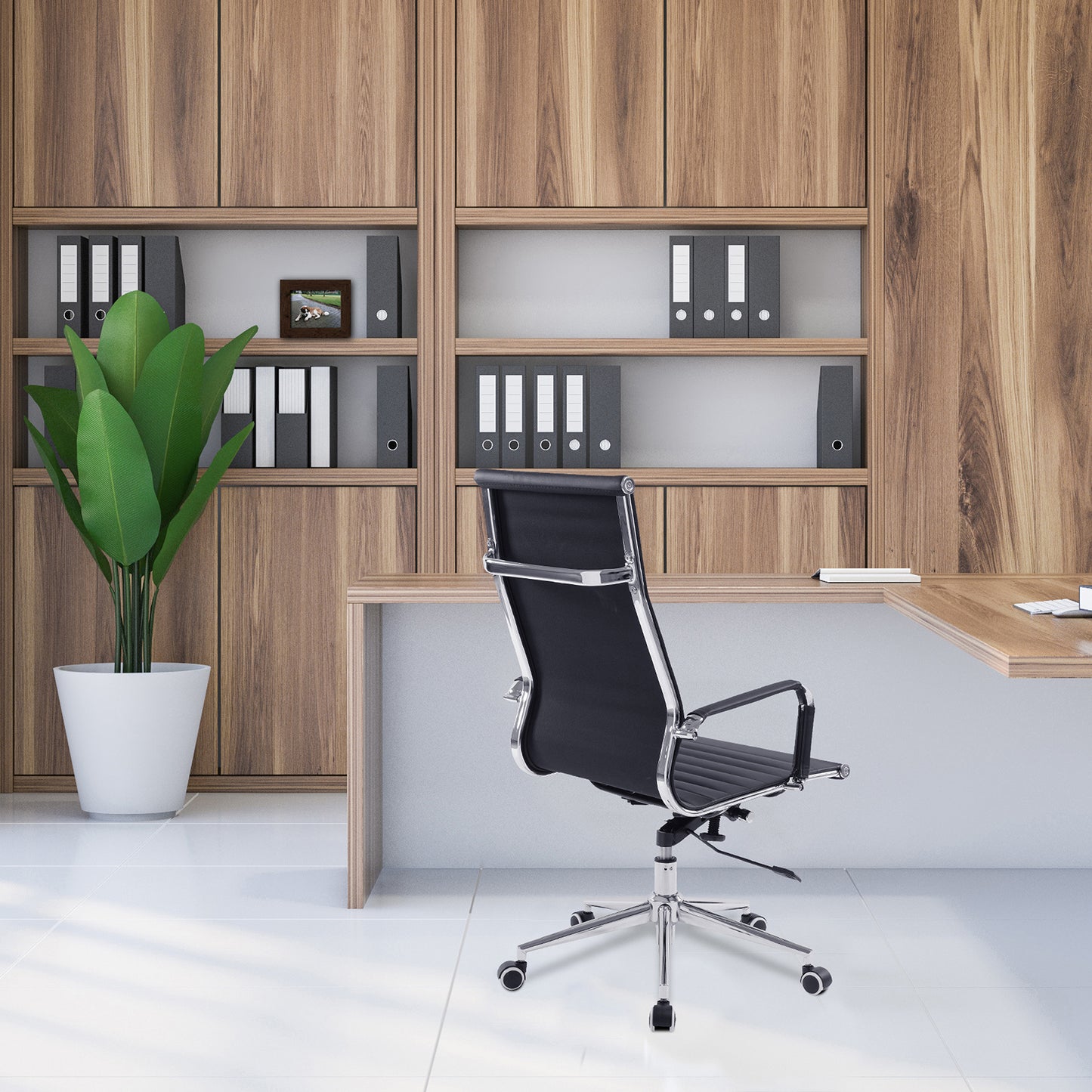 Modern office setup with wooden bookshelf, black office chair, and plant.