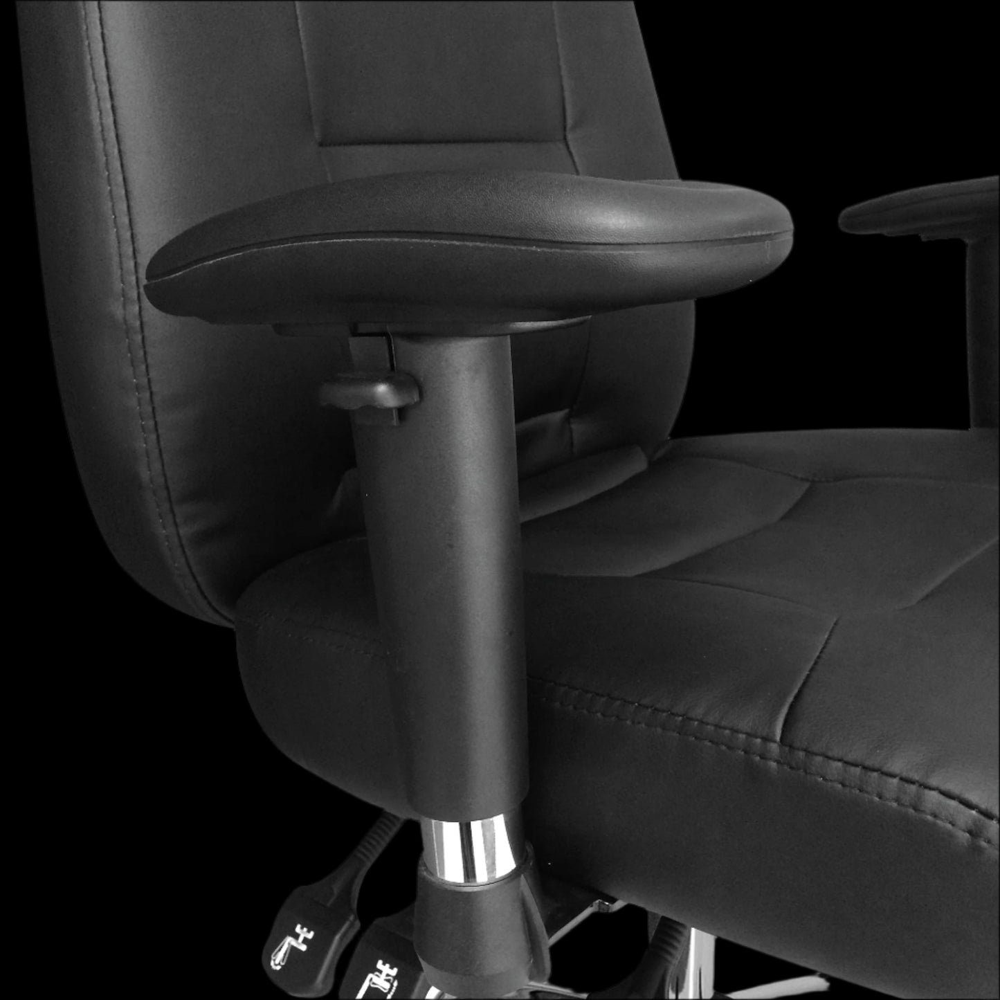 Black office chair with adjustable armrest on a black background