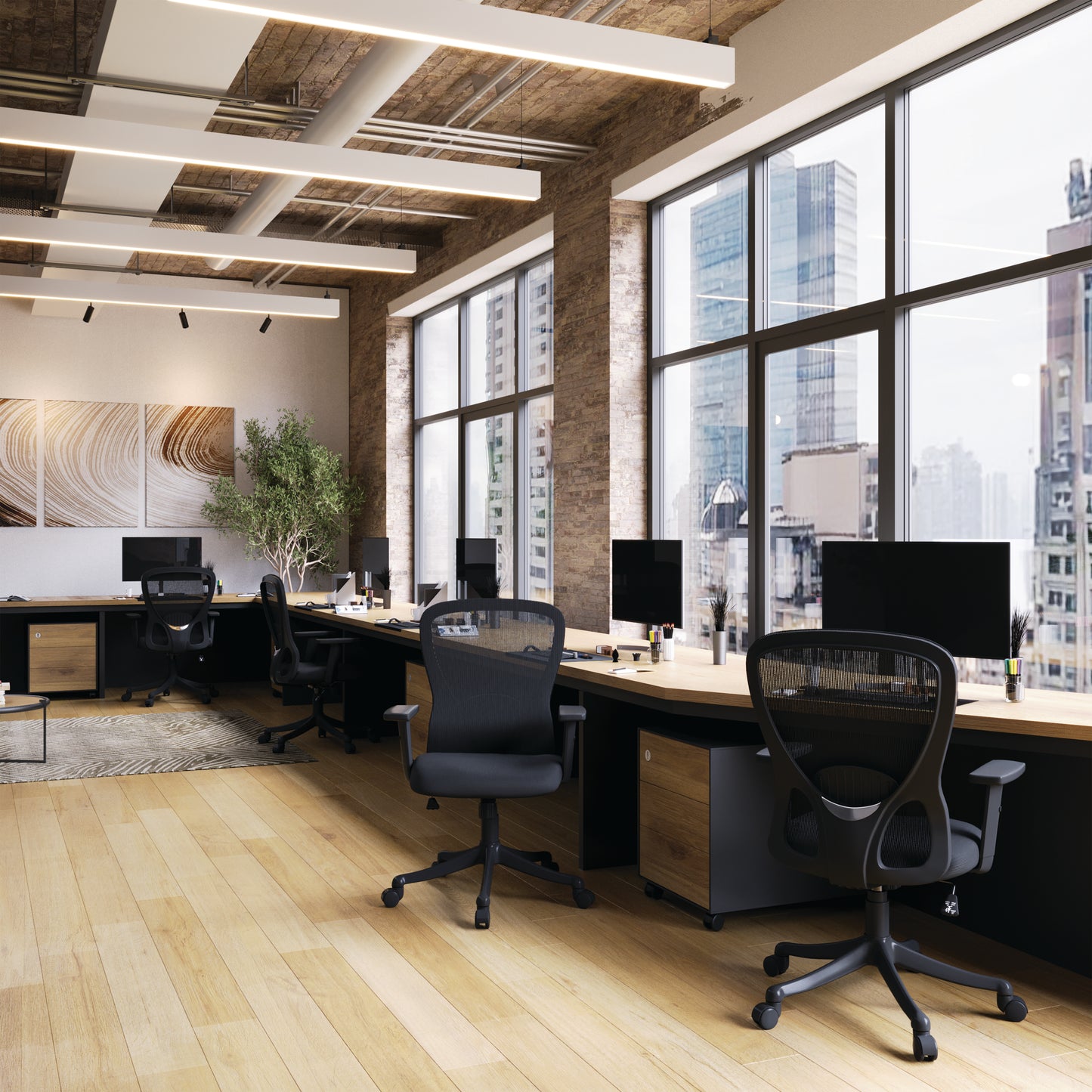 Modern office space with large windows, desks, and chairs.
