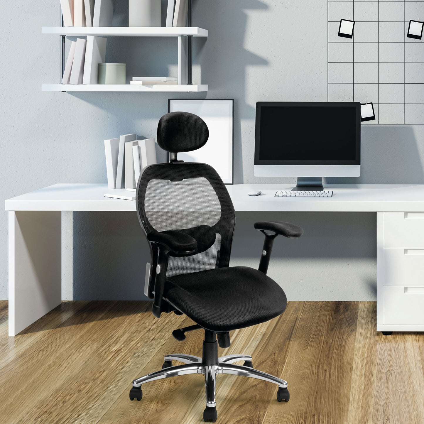 Black office chair in front of a white desk with a computer setup.