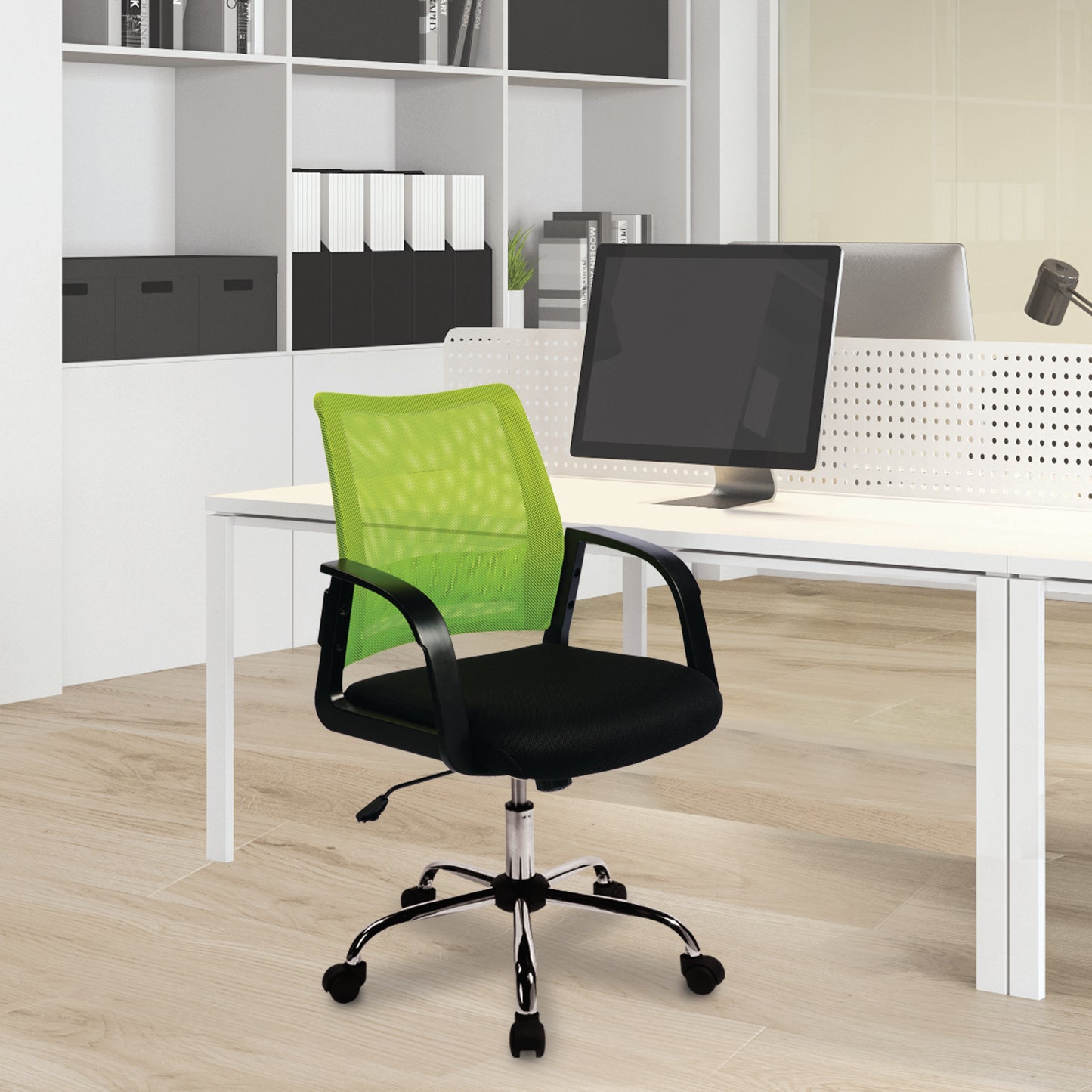 Green office chair in front of a computer desk with office equipment.
