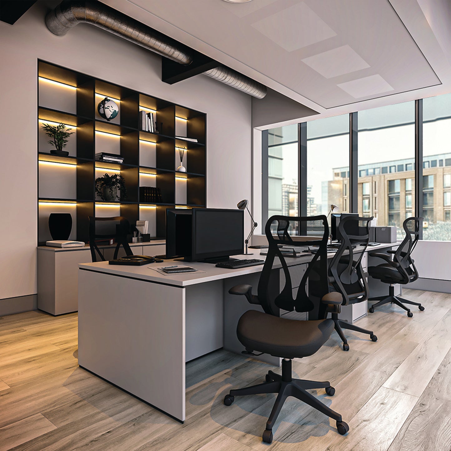 Modern office space with desks, chairs, and large windows.