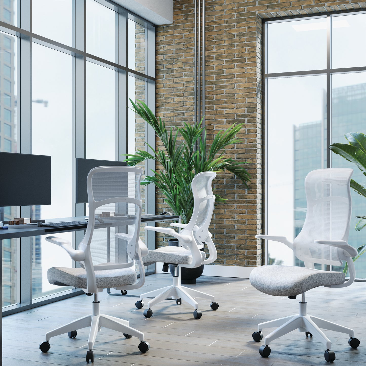 Modern office setup with ergonomic chairs and a large window view.