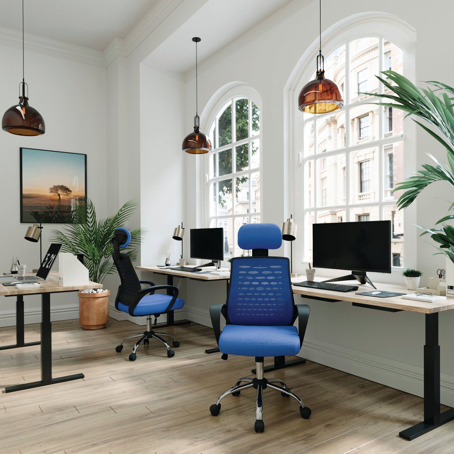 Modern office space with blue chairs, desks, and large windows.