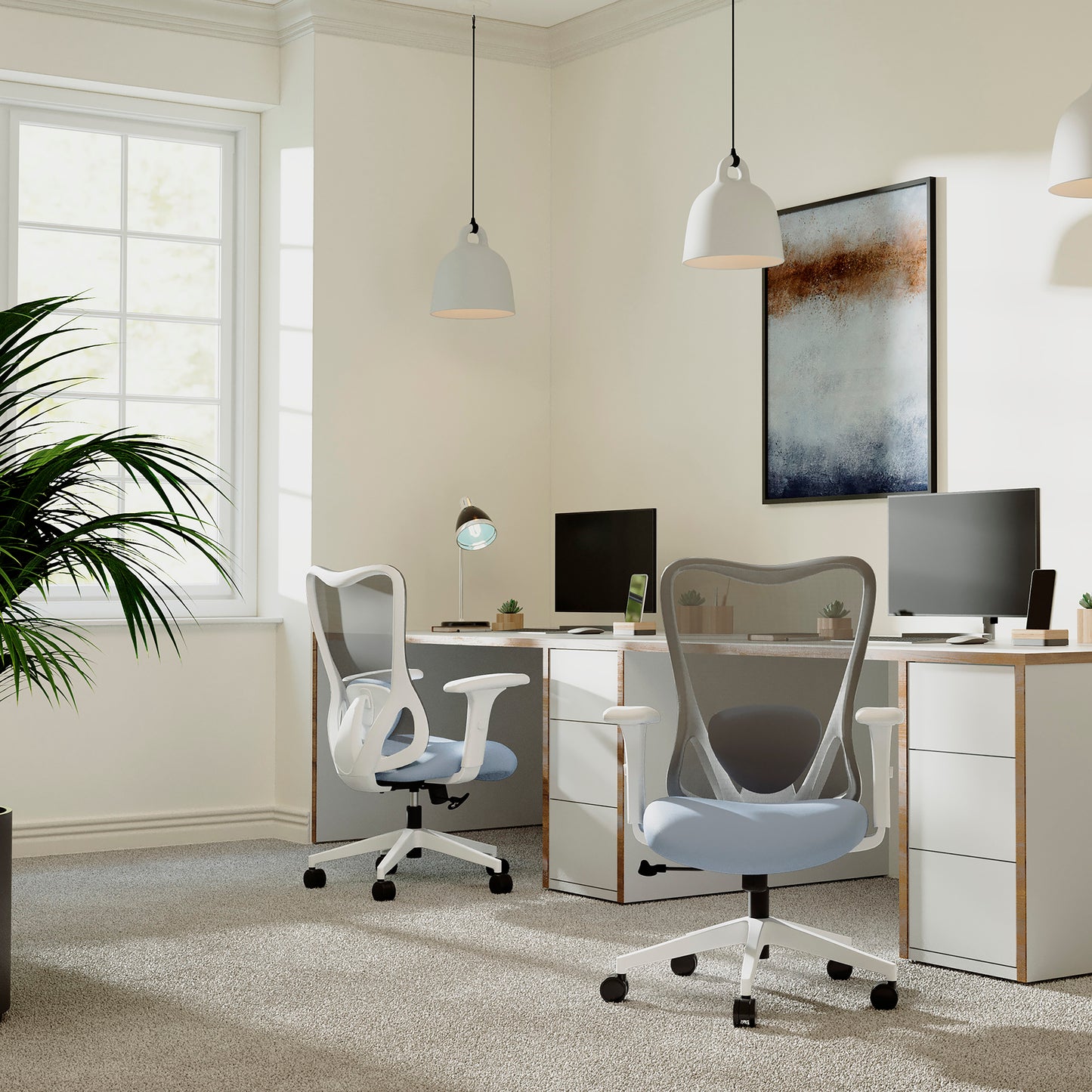 Modern office setup with two chairs, desks, and computer monitors in a bright room.