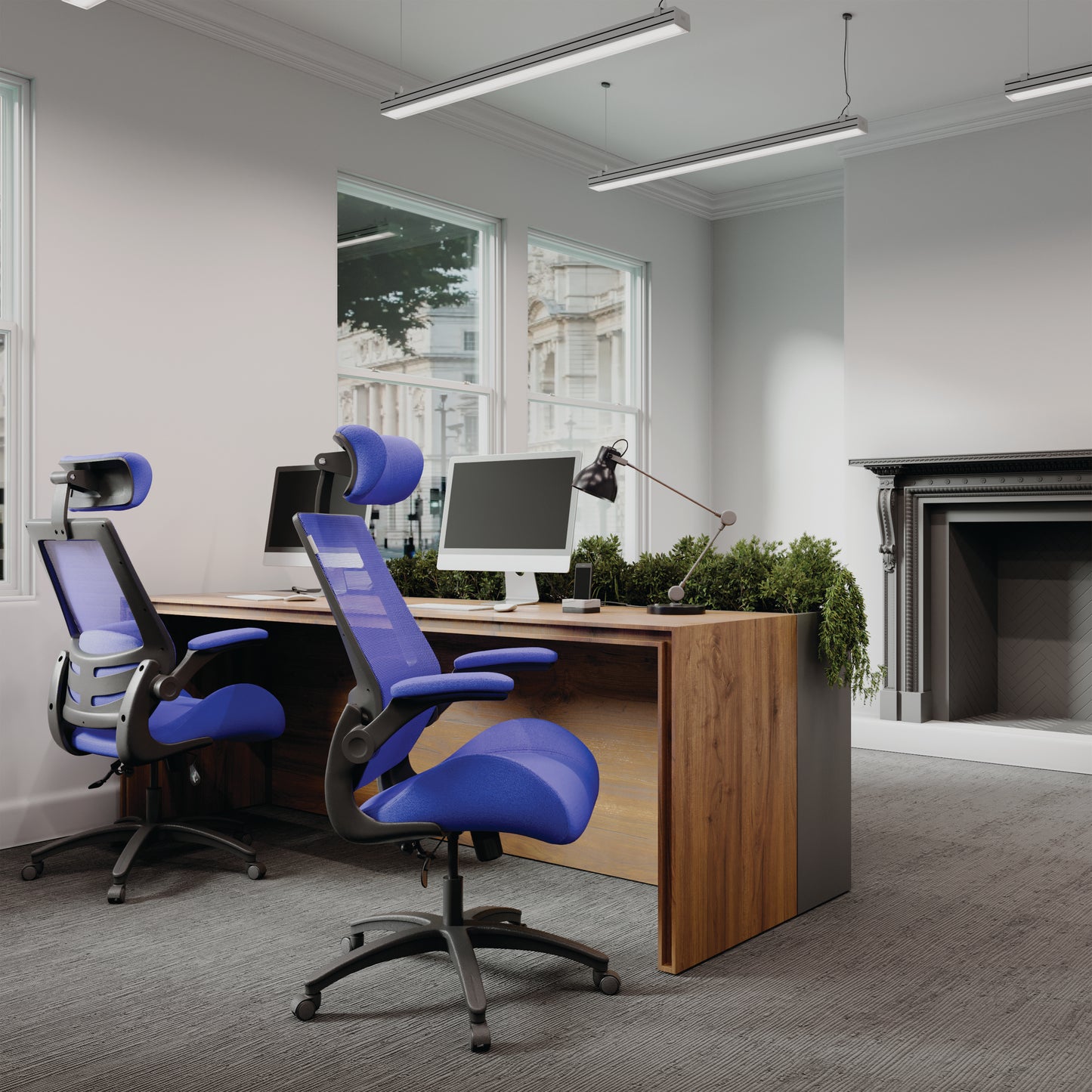 Modern office setup with blue ergonomic chairs and a wooden desk.