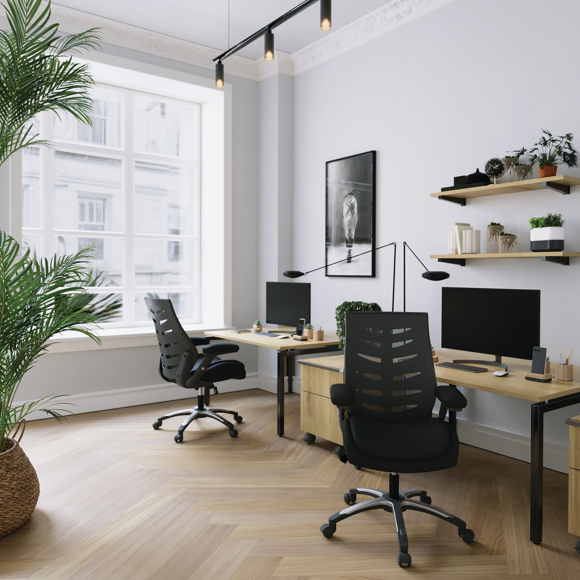 Modern office space with two desks, chairs, and decorative elements.