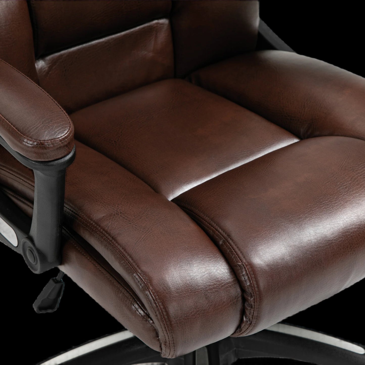 Brown leather office chair with reclining feature on a black background