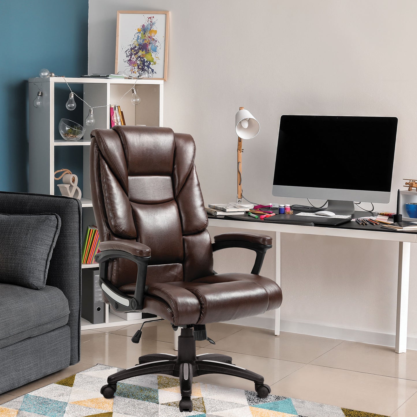 Brown leather office chair in a home office setting with a desk and computer.