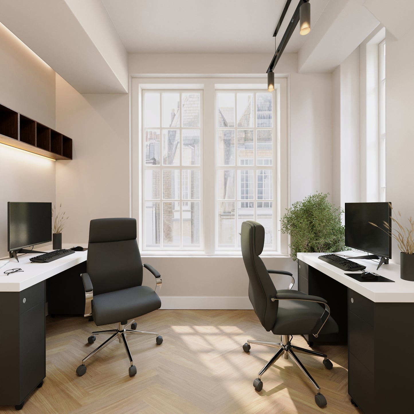 Modern office setup with two desks, chairs, and computer monitors in a well-lit room.