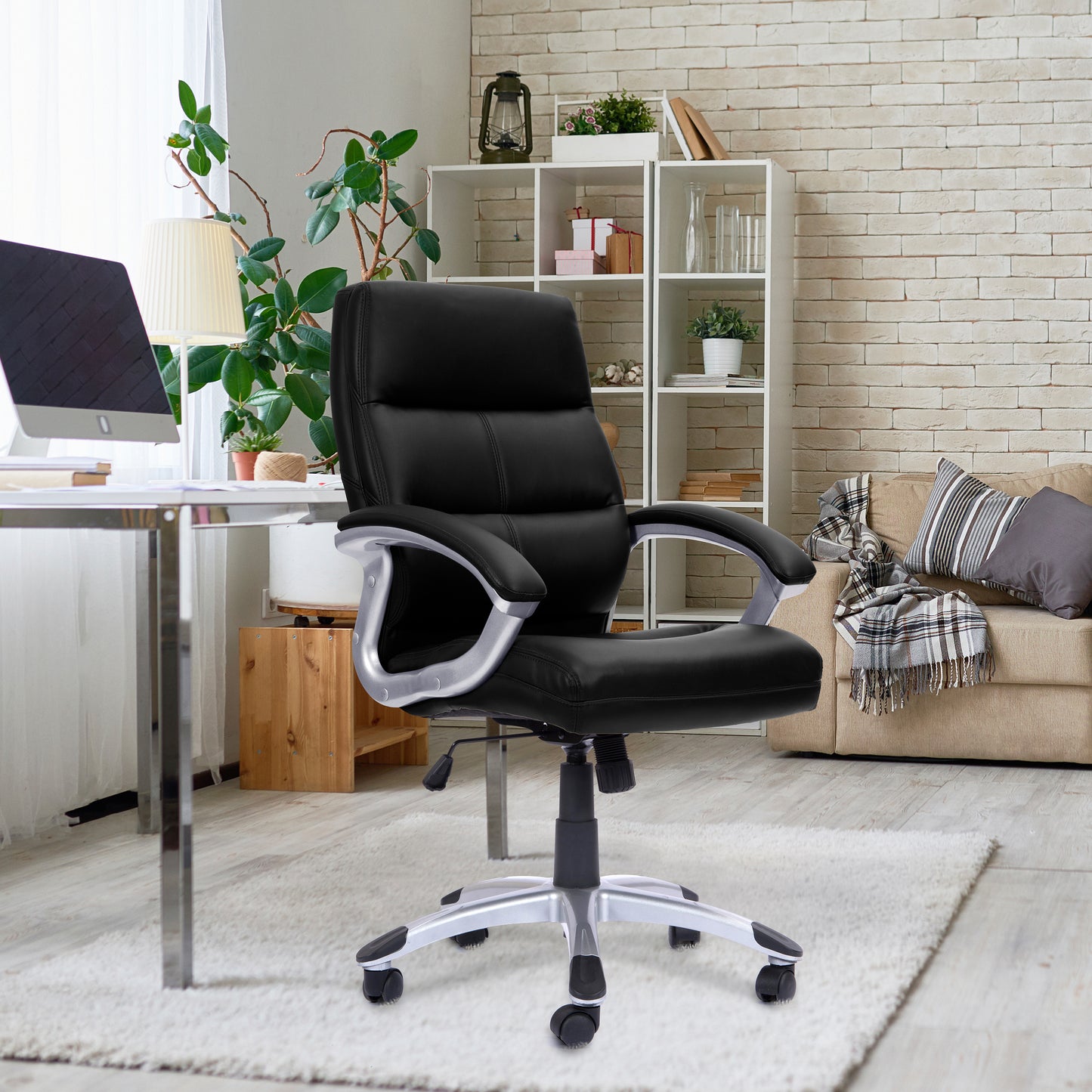 Black office chair in a home office setting with a desk, computer, and decor.