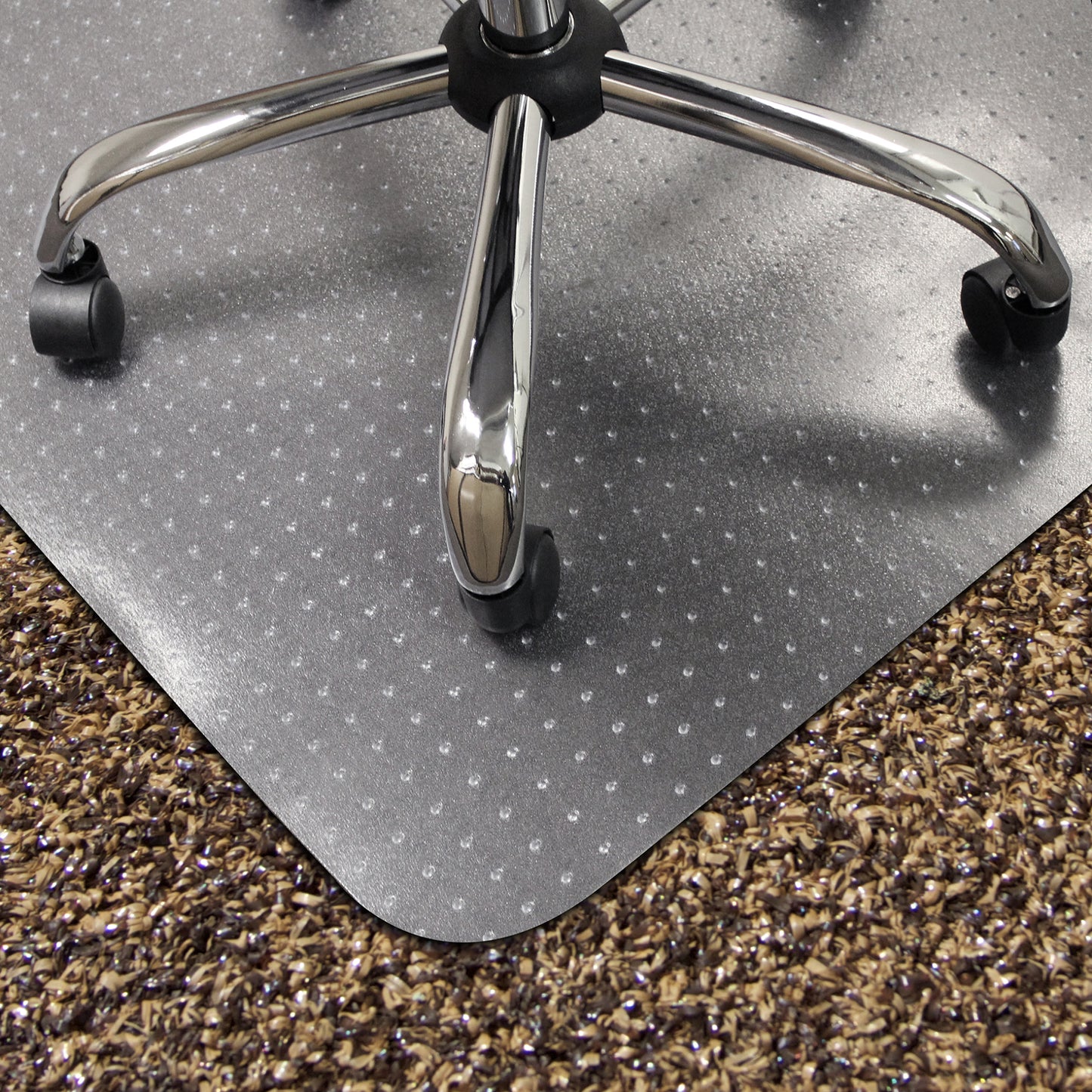Gray office chair mat on a carpeted floor with a chair wheel visible.