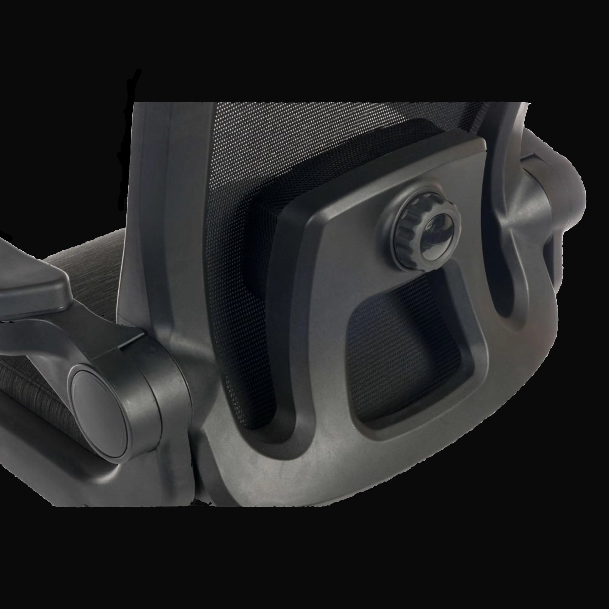 Close-up of a black office chair armrest on a black background