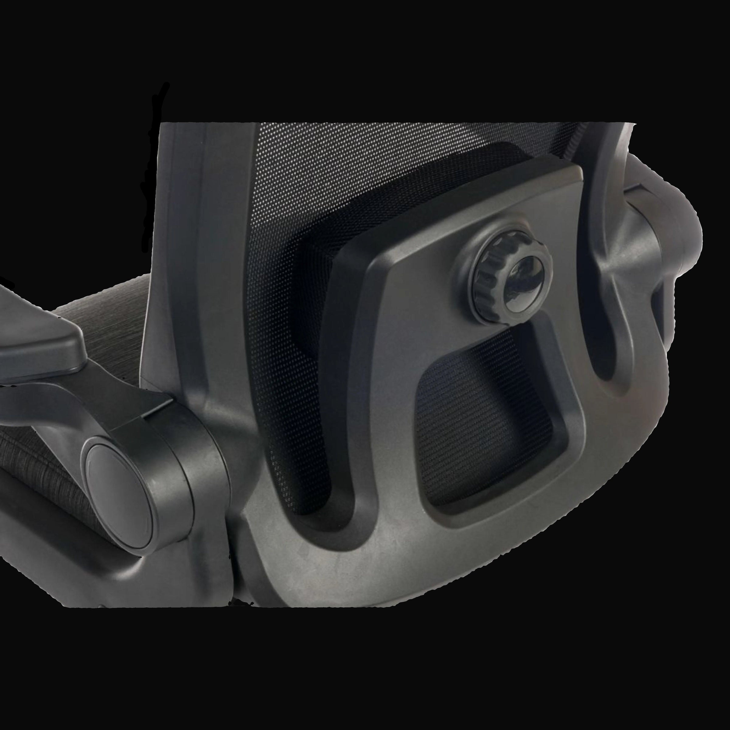 Close-up of a black office chair armrest on a black background