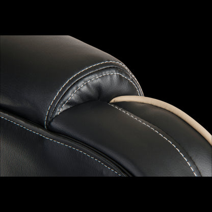 Close-up of a black leather seat with stitching detail on a black background