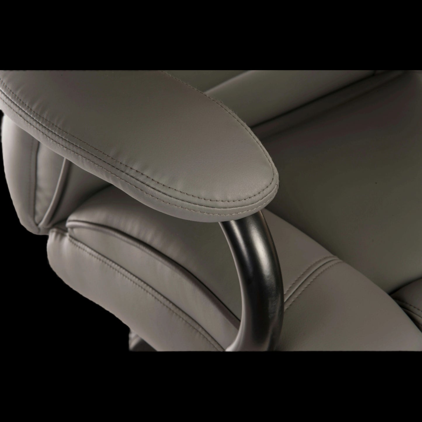 Close-up of a gray car seat with headrest on a black background