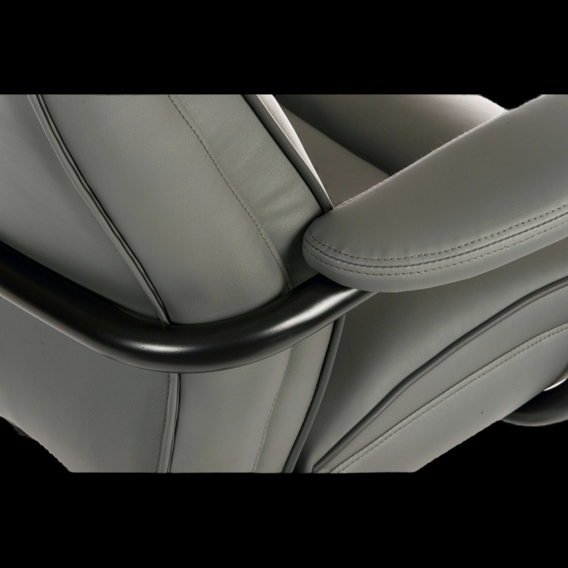 Close-up of an office chair seat with headrest and armrest