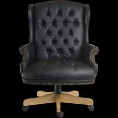 Black leather office chair with wooden base on a black background