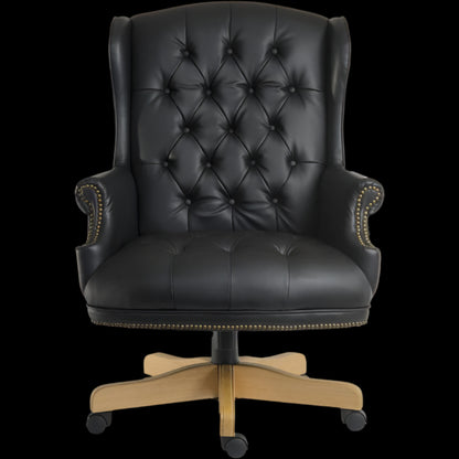 Black leather office chair with wooden base on a black background